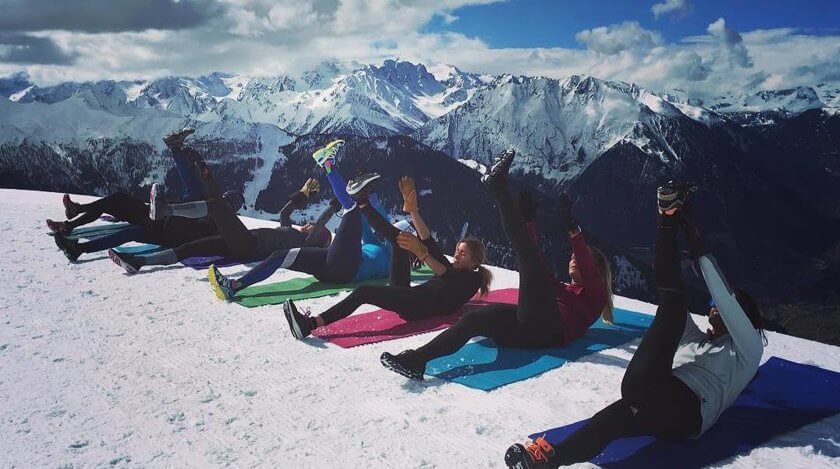 women doing yoga on the snow