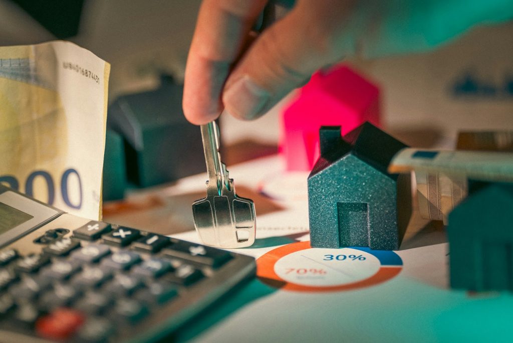 a key and a calculator on a desk