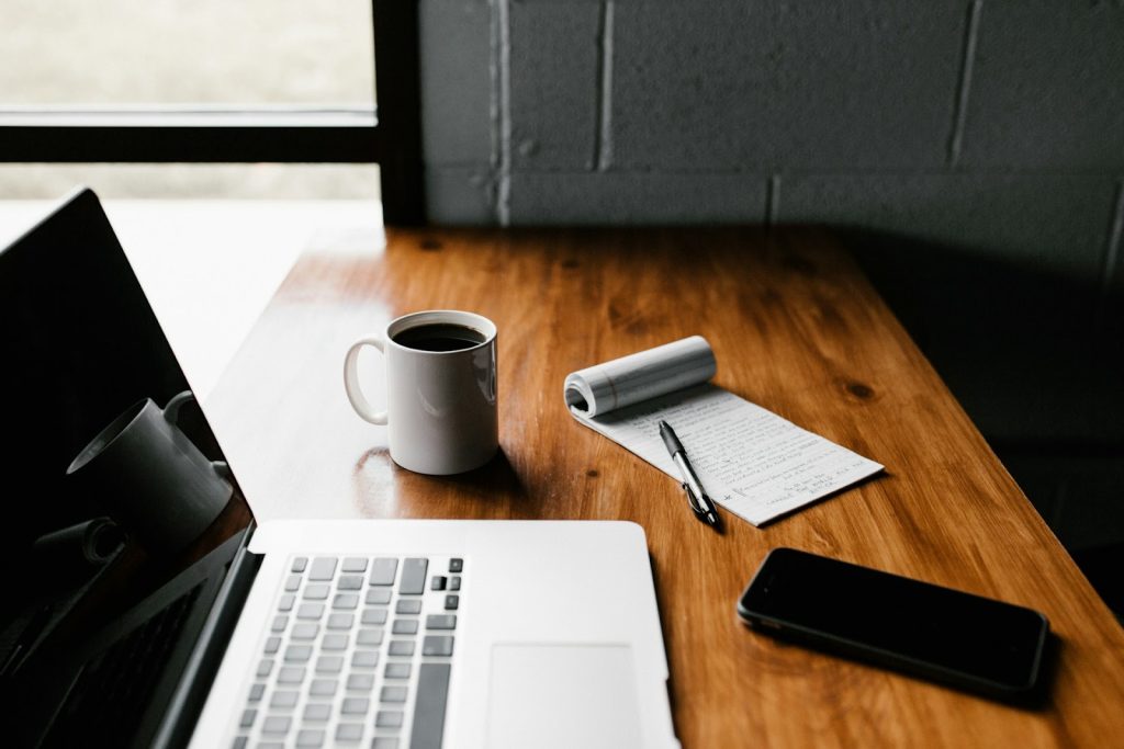 a laptop on a wooden work desk