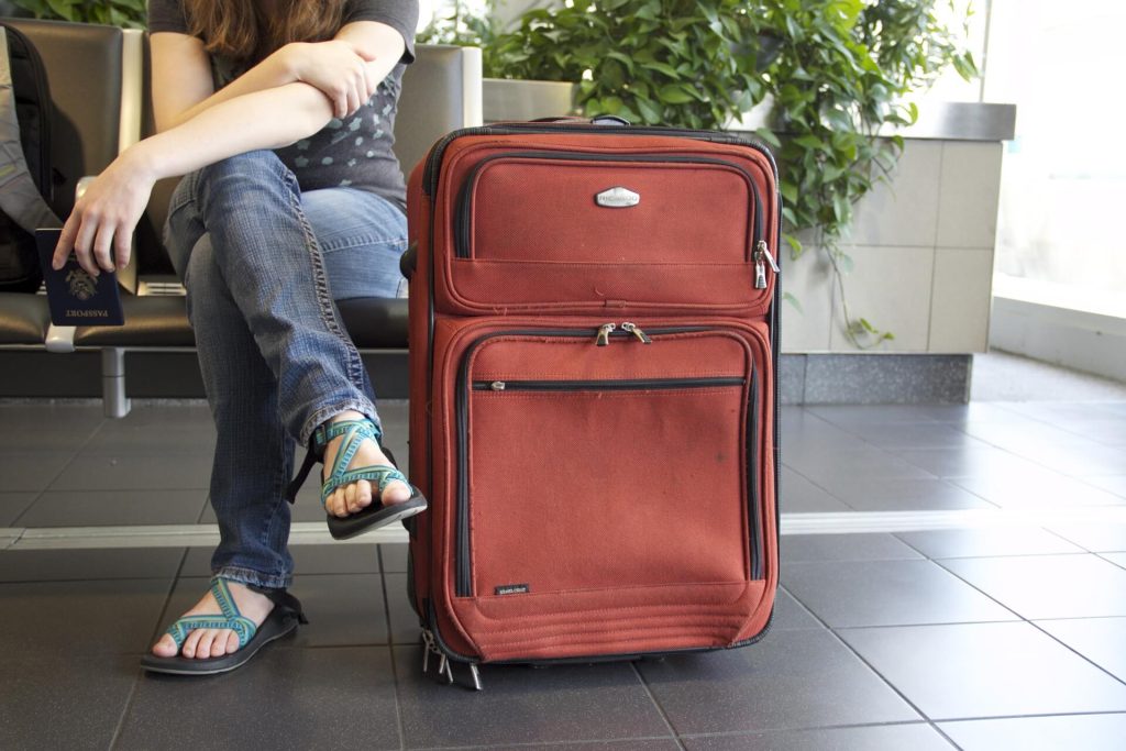 a woman sitting with a suitcase