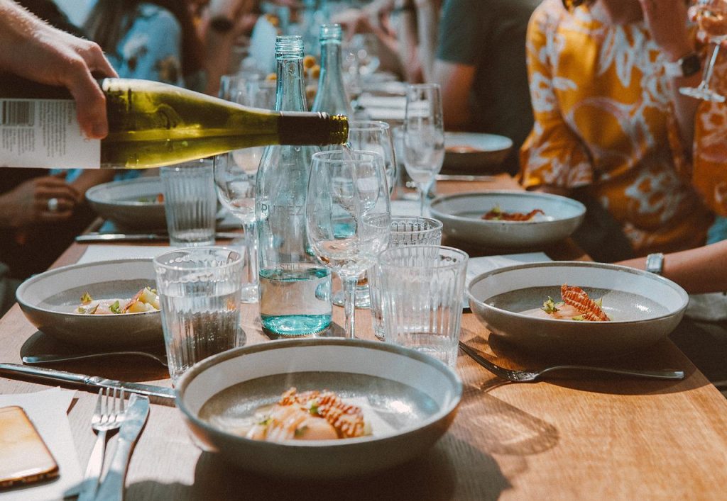 people sitting around a table with glasses