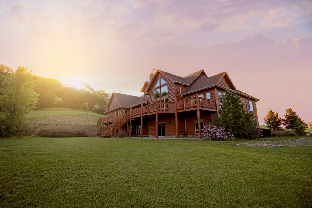 a brown house in nature during sunset