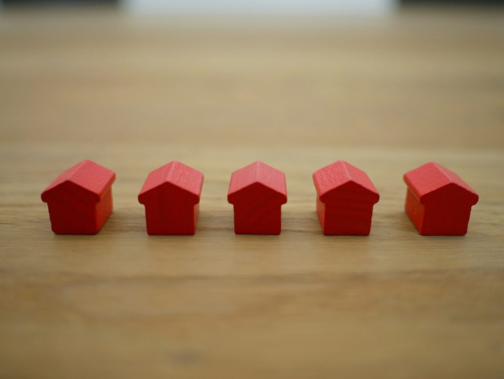 a row of five red house figures