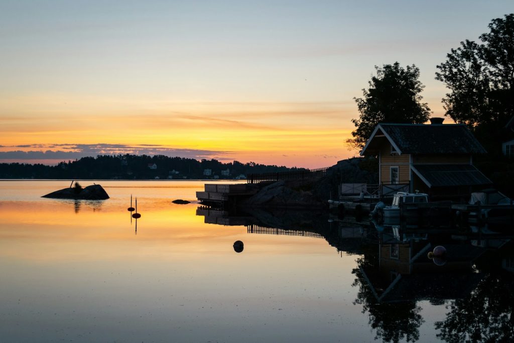 a lake house at sunset