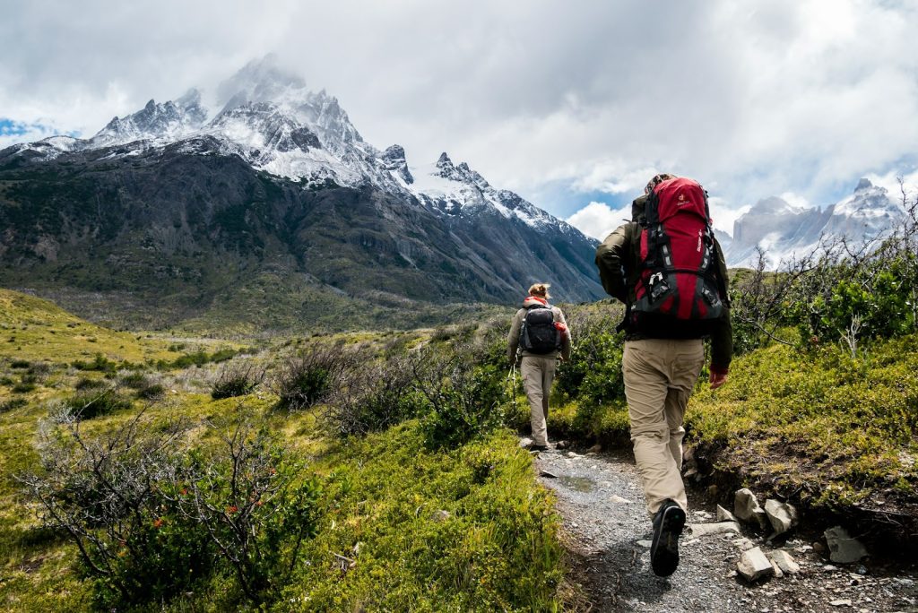 two people hiking by a mountain creek