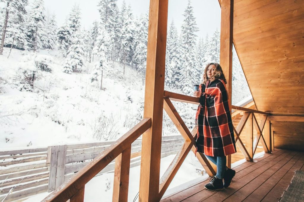 a woman standing on a chalet balcony