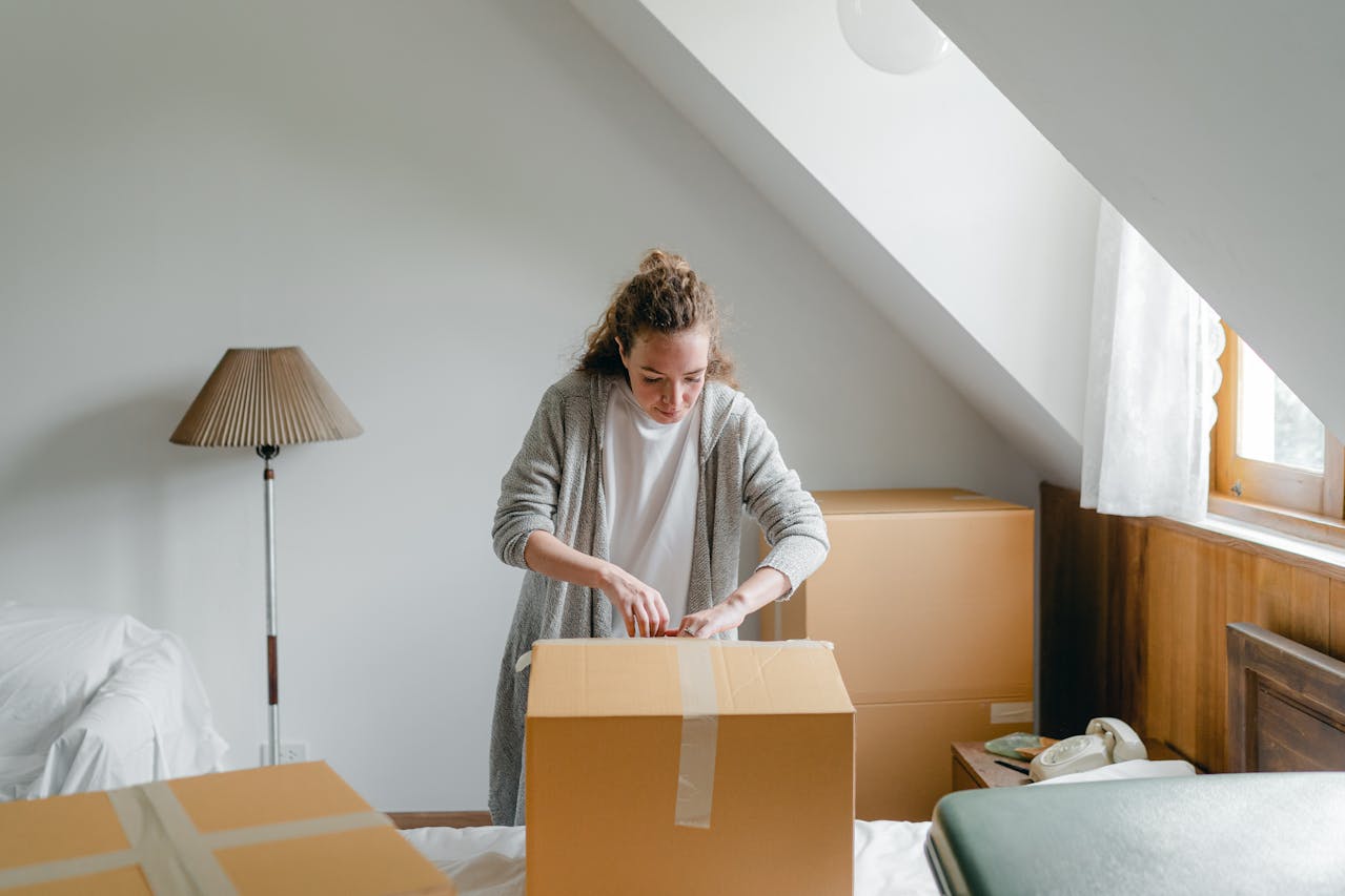 a woman duct taping a box