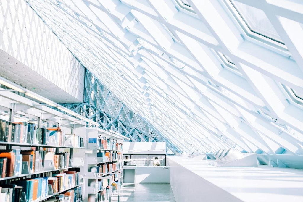 a sunlit white library