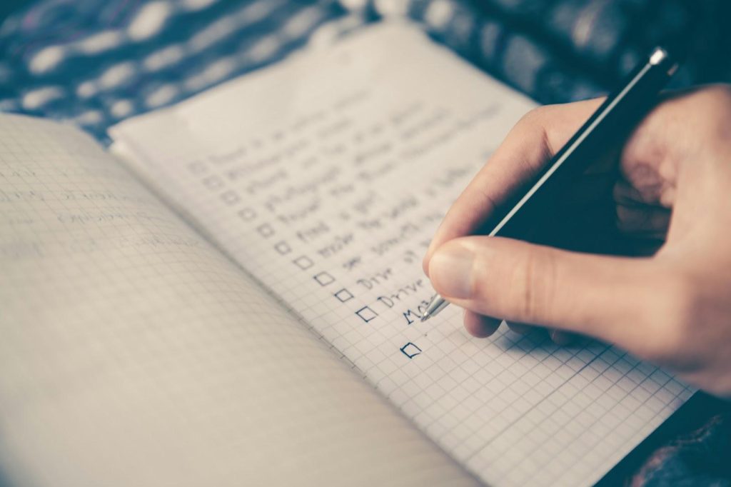 a person writing a to-do list