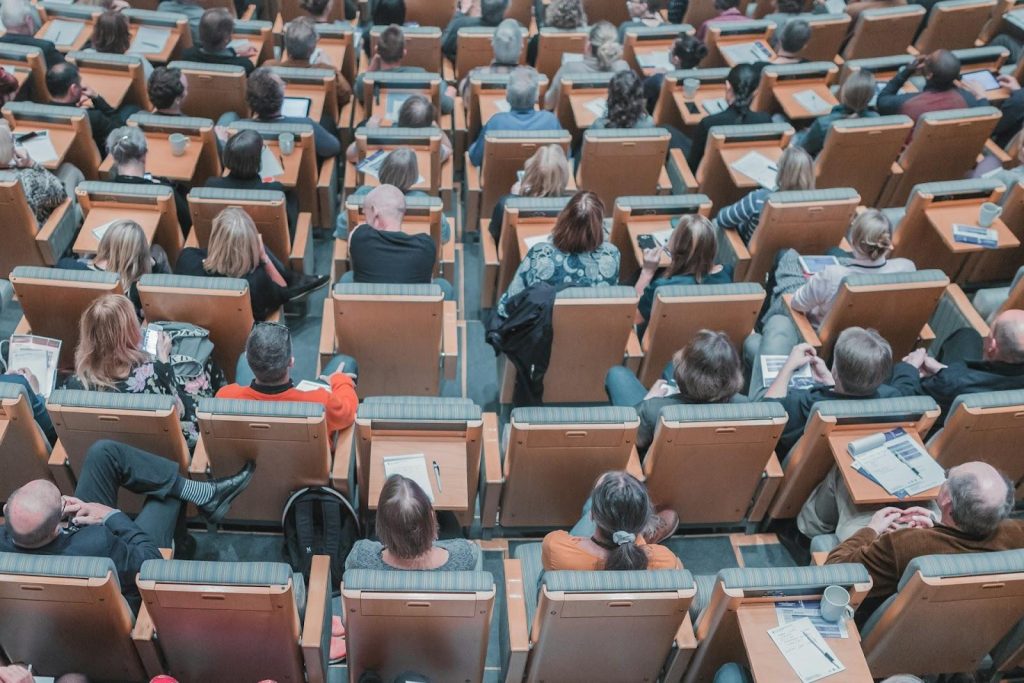 people sitting in a hall