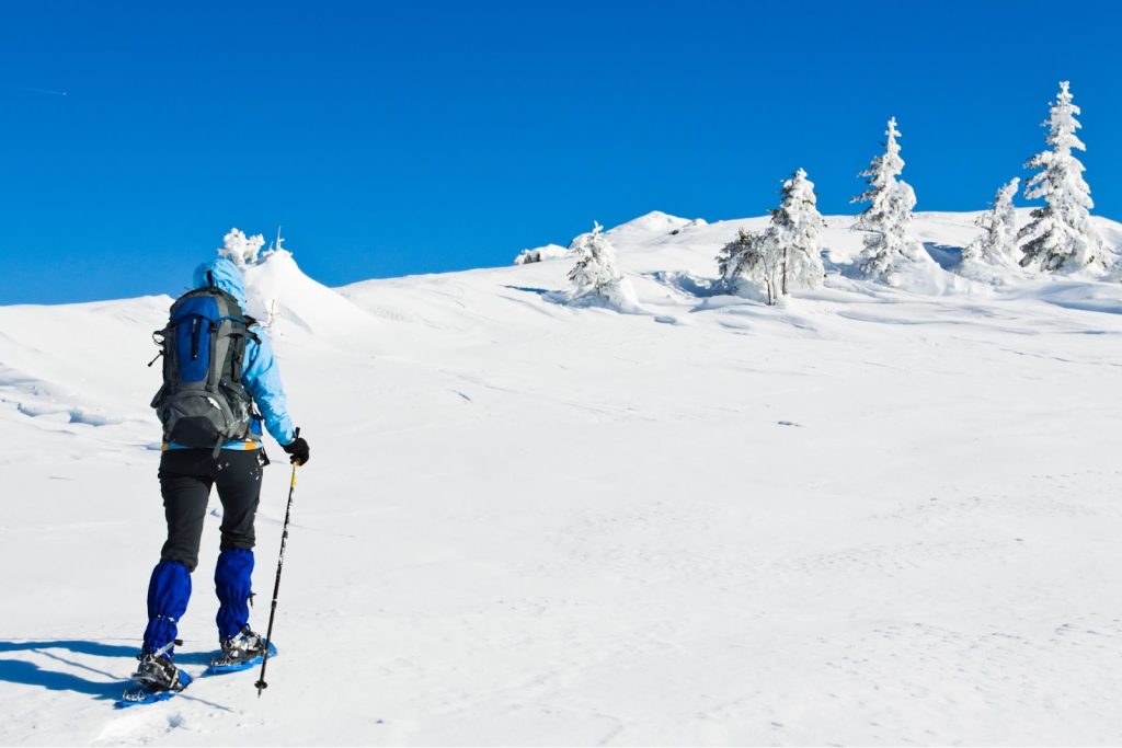 a person snowshoeing uphill